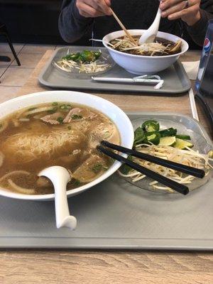 Pho with steak and meatballs for me. Signature pho across the table.