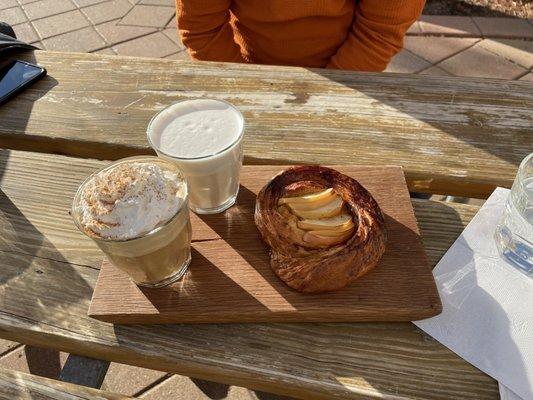 Pumpkin spice latte with whip cream.  Honey chai latte and Apple pumpkin Croissant