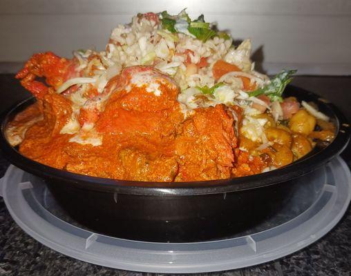 Chicken tikki, basmati rice, with chick peas and spinach and salad on top.