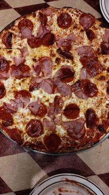 Pepperoni and ham thin crust pizza.