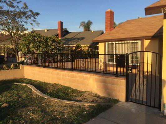 Iron fence and pedestrian gate with arch, deadbolt lock, knob, simple design, and knuckles