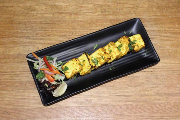 KESARI PANEER TIKKA 

Cottage cheese infused with saffron, marinated in lime juice, sour
cream & spices.