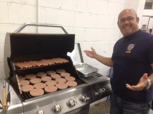 Our National Sales Manager, Al Blevins grilling burgers and dogs for our office Labor Day Picnic