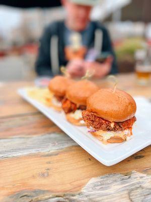 Crispy Buffalo Chicken Sliders with spicy aioli & coleslaw on brioche buns