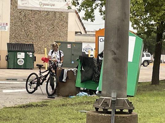 Breaking into the donation boxes and throwing the clothes on the ground