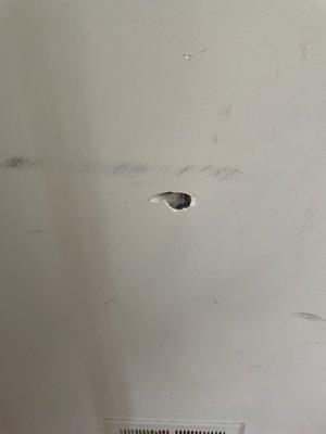 They had a lock box on the wall. When they ripped it out it left this hole!