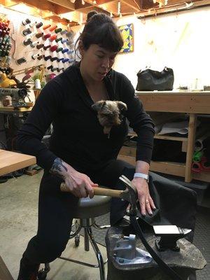 Ellie teaching us how to set rivets as shop assistant Winston supervises.