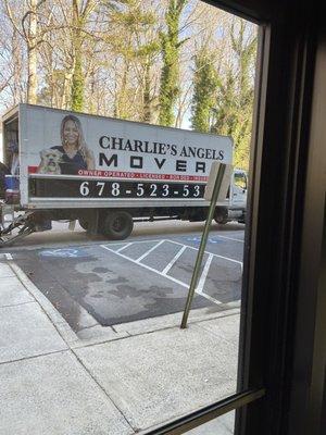 Charlie's Angels Movers truck blocking two handicapped spaces at a medical office.