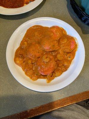 Smothered in sauce Lobster Ravioli with tiny shrimp