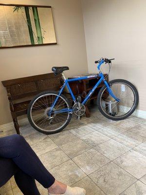 Bicycles in the waiting room blocking available seating while patients stand waiting...   Really Quinh?