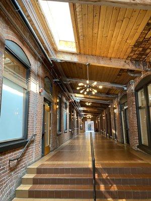 The entry way in building before their office on the left.