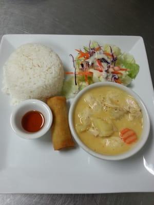 Yellow curry served with steamed rice, salad and spring roll..