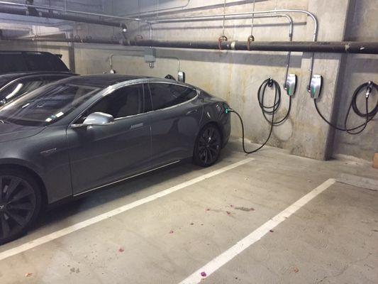 EV car charging station installed in private apartment building parking lot