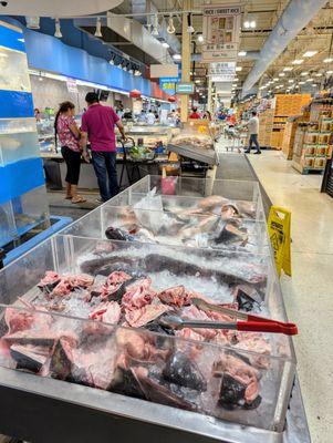 Inside the seafood section. Various fish parts including heads.