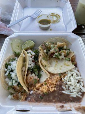 Three shrimp tacos with beans and rice. Mmmmmmm