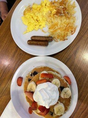 Double Berry Banana Strawberry Pancakes with eggs, sausage, and hashbrowns