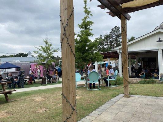 Bar and sitting area with food trucks in background