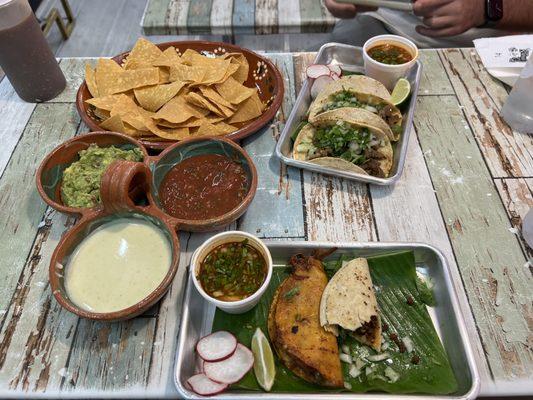 Quesa-birria taco, (half-eaten) chorizo taco, asada tacos and the Trio Dip.