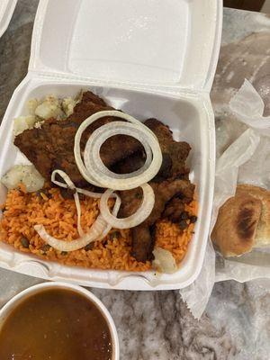 Fry steak dinner with yellow rice and garlic potato, small Cuban bread, red beans