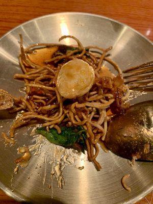 Quail egg in tamarind glaze over crispy noodles.