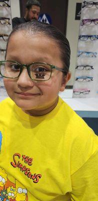 My son  picking out his new glasses in his favorite color