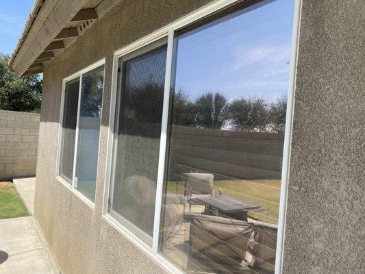 Backyard windows, pool reflects on this set.