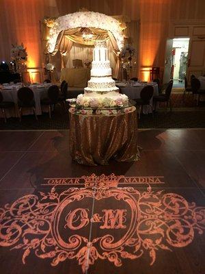 Custom monogram, pin spot lighting on cake and LED lighting on head table.