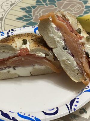 Bagel, lox, cream cream, capers,tomato at home.