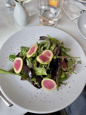 Market greens salad with shaved radishes and champagne vinaigrette.