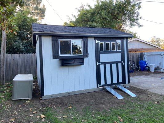 Our new shed. The window box now has trailing geraniums