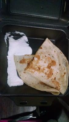 A to go order of chicken quesadilla with sourcream.