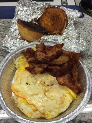 eggs with muenster cheese on top, crispy bacon and a double-toasted corn muffin with butter