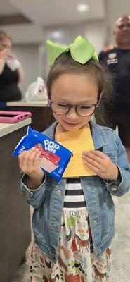 Daughter wins a treat from the hotel's snack store over a sweet deal she made with Manny.