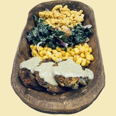 Mushroom crabless cakes seasoned and fried to perfection and drizzled with got flavor ranch, with side of sweet corn, kale the hate salad an