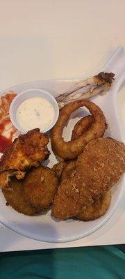 Half eaten combo platter appetizer. 2 chicken wings, two chicken tenders, 6 zucchini and a handful of onion rings.