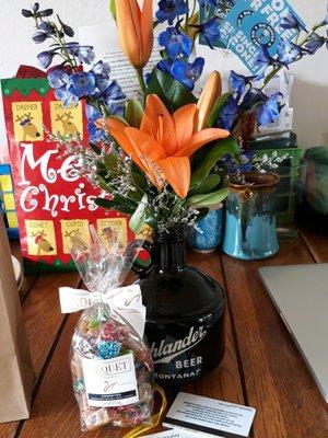 Beer growler flower arrangement, candy, and coupons