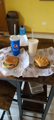 One double cheese burger, one chicken sandwich,  a soda, and a milk shake.