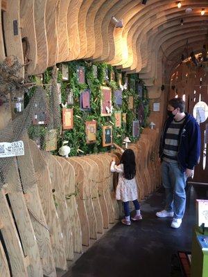 Staff helping my daughter explore mini doors of imagination. This art wall ceiling is Soooo Cool!