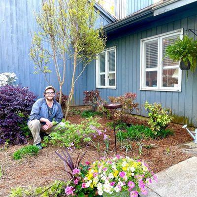 Connor from Black Dog Handyman Services in front of nandina bushes he planted for me.