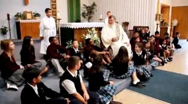 Deacon Mike gathers the students during a school Mass