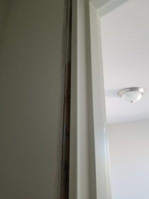 Gap between wall and the door frame.