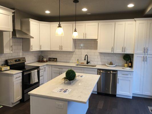 Complete remodel of kitchen (cabinets, backsplash, countertops) and floors.