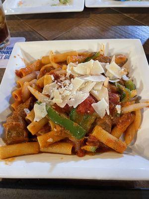 Sausage peppers and onions over penne