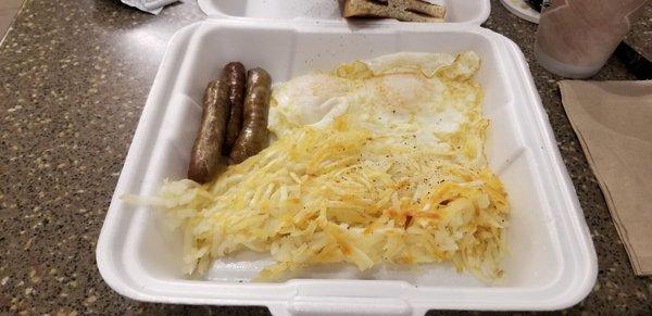 Two eggs, over medium w/sausage, hashbrowns and burned toast, $6.49.