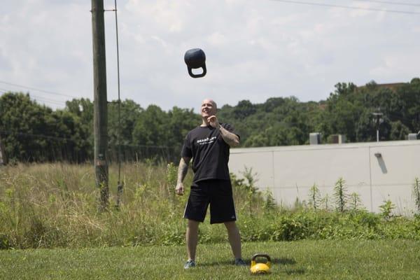 Scott demonstrating kettlebell juggling.