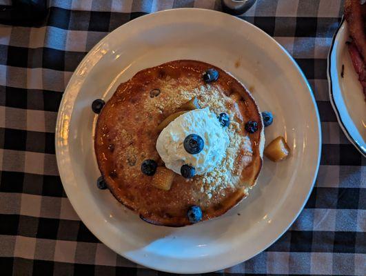 Fluffy blueberry pancake with cooked pears and a sizeable scoop of vanilla-flavored mascarpone.