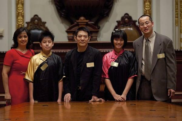 Jet Li with NYSE tour organizer Allen Tjiong and his family in the board room.