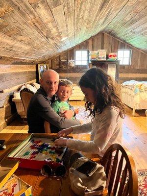 Playing board games on the second floor of the cabin.