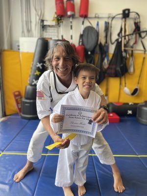 Sensei Wayne and my son after his yellow belt promotion.