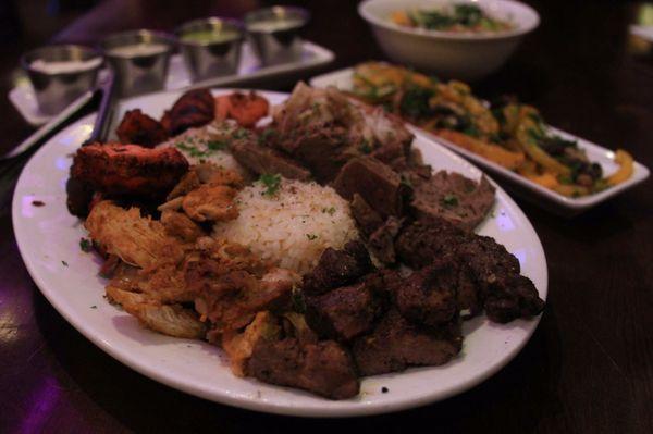 Combination kebab plate. A generous spread of kebab meats, salads, house dressings and rice.